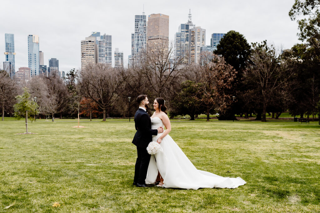 Taylah and Richard, wrapped in the quiet of Fitzroy Gardens, paused to soak in the stillness of their day. No rush, no audience — just the two of them, city skyline behind and hearts entirely present. A winter elopement grounded in intention, simplicity, and soul.
